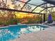 Inviting pool with screened enclosure and sunset view at 613 Mistiflower Cir, Nokomis, FL 34275