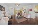 Spacious living room with hardwood floors, comfy seating, and access to the backyard at 4619 Flint Dr, North Port, FL 34286