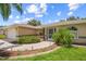 Home's exterior with a palm tree and a walkway at 4619 Flint Dr, North Port, FL 34286