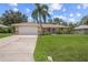 Single-story house with attached garage and a well-maintained lawn at 4619 Flint Dr, North Port, FL 34286