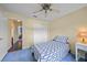 Bedroom with blue carpet, ceiling fan, and access to hallway at 4619 Flint Dr, North Port, FL 34286