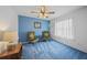 Sitting room with blue carpet, two armchairs, and ceiling fan at 4619 Flint Dr, North Port, FL 34286