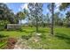 Spacious backyard with lush greenery and a shed at 4619 Flint Dr, North Port, FL 34286