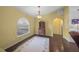 Bright dining room features hardwood floors, an arched doorway, and a charming antique secretary at 4619 Flint Dr, North Port, FL 34286