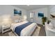Main bedroom with beige upholstered bed and blue blanket at 600 Carriage House Ln # 104, Nokomis, FL 34275