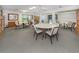 Community room with tables, chairs, and a library at 600 Carriage House Ln # 104, Nokomis, FL 34275