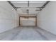 Empty garage with overhead door and concrete floor at 600 Carriage House Ln # 104, Nokomis, FL 34275
