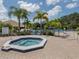 Relaxing community hot tub surrounded by lush landscaping at 600 Carriage House Ln # 104, Nokomis, FL 34275