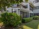 Building exterior with lush landscaping and a patio at 600 Carriage House Ln # 104, Nokomis, FL 34275