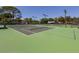 Outdoor tennis courts with ample space for playing at 600 Carriage House Ln # 104, Nokomis, FL 34275