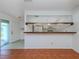 Kitchen with pass-through to living area and white cabinets at 600 Carriage House Ln # 104, Nokomis, FL 34275