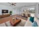 Open living room and dining area with tile flooring and a view of the kitchen at 600 Carriage House Ln # 104, Nokomis, FL 34275