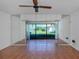 Living area with mirrored walls and sliding glass doors leading to a patio at 600 Carriage House Ln # 104, Nokomis, FL 34275
