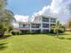 Two-story building exterior with a large grassy area at 600 Carriage House Ln # 104, Nokomis, FL 34275