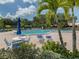 Inviting community pool with lounge chairs and patio tables at 600 Carriage House Ln # 104, Nokomis, FL 34275