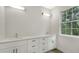 Bright bathroom with double vanity and large window at 286 Krieger St, Port Charlotte, FL 33953