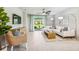 Open concept living room with a white sectional sofa, and a large TV at 2133 Royal Tern Cir, Punta Gorda, FL 33983