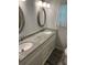 Double vanity bathroom with granite countertops and updated fixtures at 406 Trento, Venice, FL 34285
