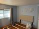 Serene bedroom featuring wood floors and light walls at 406 Trento, Venice, FL 34285