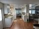 Open concept kitchen with white cabinets and wood flooring at 406 Trento, Venice, FL 34285