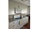 Modern kitchen with white cabinets and tile backsplash at 406 Trento, Venice, FL 34285