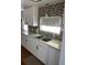 Updated kitchen with white cabinets and double sink at 406 Trento, Venice, FL 34285