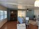 Living room with wood flooring, a sofa and a built-in hutch at 406 Trento, Venice, FL 34285