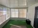 Relaxing sunroom with green carpet and plenty of windows at 406 Trento, Venice, FL 34285