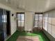 Bright sunroom featuring a door and green flooring at 406 Trento, Venice, FL 34285
