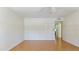 Neutral bedroom with ceiling fan and view to a hallway at 8 Quails Run Blvd # 6, Englewood, FL 34223