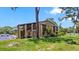 Exterior of condo with stairway, balcony and lawn at 8 Quails Run Blvd # 6, Englewood, FL 34223