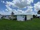 Side view of a yellow mobile home showcasing its exterior at 406 Trento, Venice, FL 34285