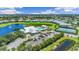 Aerial view showing community pool, tennis courts, clubhouse, and parking at 2129 Royal Tern Cir, Punta Gorda, FL 33983