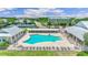 Community pool with lounge chairs and covered areas at 2129 Royal Tern Cir, Punta Gorda, FL 33983