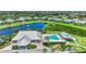Aerial view of community pool, clubhouse, tennis courts, and lake at 2129 Royal Tern Cir, Punta Gorda, FL 33983