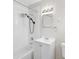 Clean bathroom with white tile, vanity, and a shower/tub combination at 2143 Starlite Ln, Port Charlotte, FL 33952