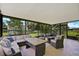 Relaxing screened porch with patio furniture and backyard view at 2143 Starlite Ln, Port Charlotte, FL 33952