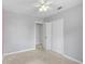 Bright bedroom with carpet, ceiling fan, and double door closet at 2143 Starlite Ln, Port Charlotte, FL 33952