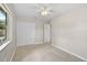 Well-lit bedroom featuring a ceiling fan and ample closet space at 2143 Starlite Ln, Port Charlotte, FL 33952