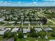 High-angle view of a residential neighborhood with houses, streets and lush greenery at 2143 Starlite Ln, Port Charlotte, FL 33952