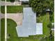 Overhead view of a house showcasing its roofline, driveway, and surrounding yard at 2143 Starlite Ln, Port Charlotte, FL 33952