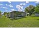 House exterior showcasing a large backyard and screened patio at 2143 Starlite Ln, Port Charlotte, FL 33952