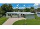 Single-story house with light green exterior, driveway, and yard at 2143 Starlite Ln, Port Charlotte, FL 33952