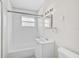 Clean bathroom with white tile, bathtub, and vanity at 2143 Starlite Ln, Port Charlotte, FL 33952