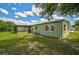 Home's exterior with a green lawn and screened patio at 2143 Starlite Ln, Port Charlotte, FL 33952