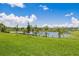 Scenic view of a tranquil lake with lush green grass at 2133 Royal Tern Cir, Punta Gorda, FL 33983