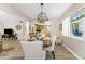 Dining area with a modern chandelier, open to kitchen and living room at 1840 Vera Pl # 81, Sarasota, FL 34235