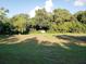 Large grassy backyard with lush trees at 5709 33Rd E St, Bradenton, FL 34203