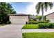 Single-story home with attached garage and well-manicured lawn at 11103 Batello Dr, Venice, FL 34292