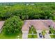 Aerial view of a home with a brown tile roof and a two car garage at 11103 Batello Dr, Venice, FL 34292